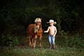 Young cowboy with horse