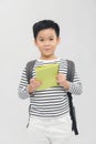 Young preschool student carrying backpack and notebooks - isolated over white