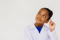 Young preteen African American kid wearing lab coat thinking