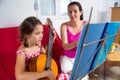 Young preteen girl having guitar lesson at home