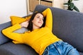 Young pretty adult woman lying on sofa relaxing at home Royalty Free Stock Photo