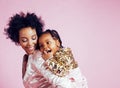 Young pretty african-american mother with little cute daughter hugging, happy smiling on pink background, lifestyle Royalty Free Stock Photo