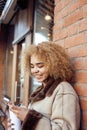 Young pretty african american women drinking coffee outside in cafe, modern business woman lifestyle concept Royalty Free Stock Photo