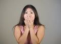 Young pretty and amazed Asian Korean girl astonished and shocked in wonder and surprise gesturing with hands covering mouth isolat Royalty Free Stock Photo