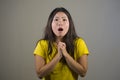 Young pretty and amazed Asian Korean girl astonished and shocked in wonder and surprise gesturing with hands and wide open mouth i Royalty Free Stock Photo