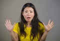Young pretty and amazed Asian Korean girl astonished and shocked in wonder and surprise gesturing with hands and wide open mouth i Royalty Free Stock Photo