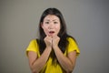 Young pretty and amazed Asian Korean girl astonished and shocked in wonder and surprise gesturing with hands and wide open mouth i Royalty Free Stock Photo