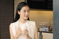 Young and pretty asia woman with cup of coffee smile in cafe