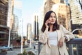 Young pretty Asian business woman standing on city street making phone call. Royalty Free Stock Photo