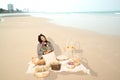 Young pretty Asian fat woman sitting on clothes on the beach.