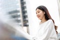 Young pretty Asian girl listening to music on earphones