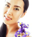 Young pretty asian woman with flower orchid close up isolated sp Royalty Free Stock Photo