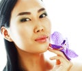 Young pretty asian woman with flower orchid close up isolated sp Royalty Free Stock Photo