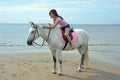 Young pretty asian woman riding white horse Royalty Free Stock Photo