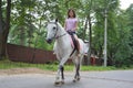 Young pretty asian woman riding white horse Royalty Free Stock Photo