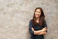 Young pretty asian woman smiling in grey concrete wall background Royalty Free Stock Photo