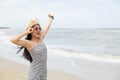 Pretty asian woman in straw hat happy on the beach