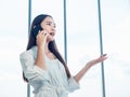 Young pretty Asian woman talking on the phone call. Portrait of Beautiful business woman using mobile phone in conversation Royalty Free Stock Photo