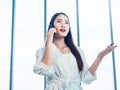 Young pretty Asian woman talking on the phone call. Portrait of Beautiful business woman using mobile phone in conversation Royalty Free Stock Photo