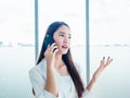 Young pretty Asian woman talking on the phone call. Portrait of Beautiful business woman using mobile phone in conversation Royalty Free Stock Photo