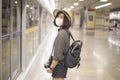 A young pretty Asian woman is wearing protective mask standing in metro station, New normal travel, covid-19 protection , safe Royalty Free Stock Photo