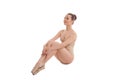 Young pretty ballet dancer sitting in elegant pose Royalty Free Stock Photo