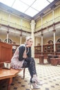 Young pretty blond girl posing in fashion style at vintage europe hall interior, lifestyle rich people concept