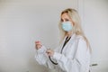 Doctor holding the thermometer on a white background with copy space. Focus is at the doctor