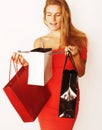 young pretty blond woman with bags on Christmas sale in red dres Royalty Free Stock Photo