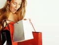 Young pretty blond woman with bags on Christmas sale in red dress isolated white Royalty Free Stock Photo