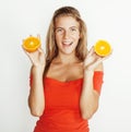 Young pretty blond woman with half oranges close up isolated on white bright teenage smiling Royalty Free Stock Photo