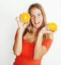 Young pretty blond woman with half oranges close up isolated on white bright teenage smiling Royalty Free Stock Photo