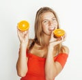 Young pretty blond woman with half oranges close up isolated on white bright teenage smiling Royalty Free Stock Photo