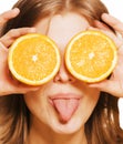 Young pretty blond woman with half oranges close Royalty Free Stock Photo