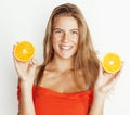 young pretty blond woman with half oranges close up  on white bright teenage smiling Royalty Free Stock Photo