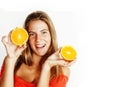 Young pretty blond woman with half oranges close up on Royalty Free Stock Photo