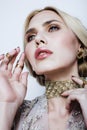 Young pretty blond woman in luxury jewelry, lifestyle rich people concept Royalty Free Stock Photo