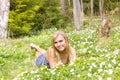 Young pretty blond woman meadow spring flowers Royalty Free Stock Photo