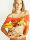 Young pretty blond woman at shopping with food in paper bag isolated on white smiling bright Royalty Free Stock Photo