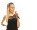 Young pretty blond woman singing in microphone isolated close up karaoke Royalty Free Stock Photo