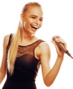 Young pretty blond woman singing in microphone isolated close up Royalty Free Stock Photo