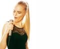 Young pretty blond woman singing in microphone isolated close up karaoke Royalty Free Stock Photo