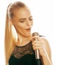 Young pretty blond woman singing in microphone isolated close up karaoke Royalty Free Stock Photo