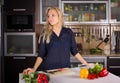 Young pretty young woman cooking salad in kitchen Royalty Free Stock Photo