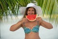 Girl with watermelon under palm tree Royalty Free Stock Photo
