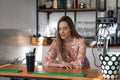 Young, pretty, blonde woman in flower dress, smiling and pensive, leaning behind the bar of a pub. Concept pubs, thoughts, hotel Royalty Free Stock Photo