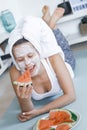 Young Pretty Blonde woman with towel on head and facial mask wit