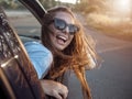 Young Girl Enjoys Feeling Wind Leaning Out of Car Window Royalty Free Stock Photo