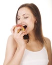 Young pretty brunette girl eating red apple Royalty Free Stock Photo