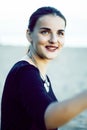 Young pretty brunette girl with long hair waiting alone on sand at seacoast, lifestyle people concept Royalty Free Stock Photo